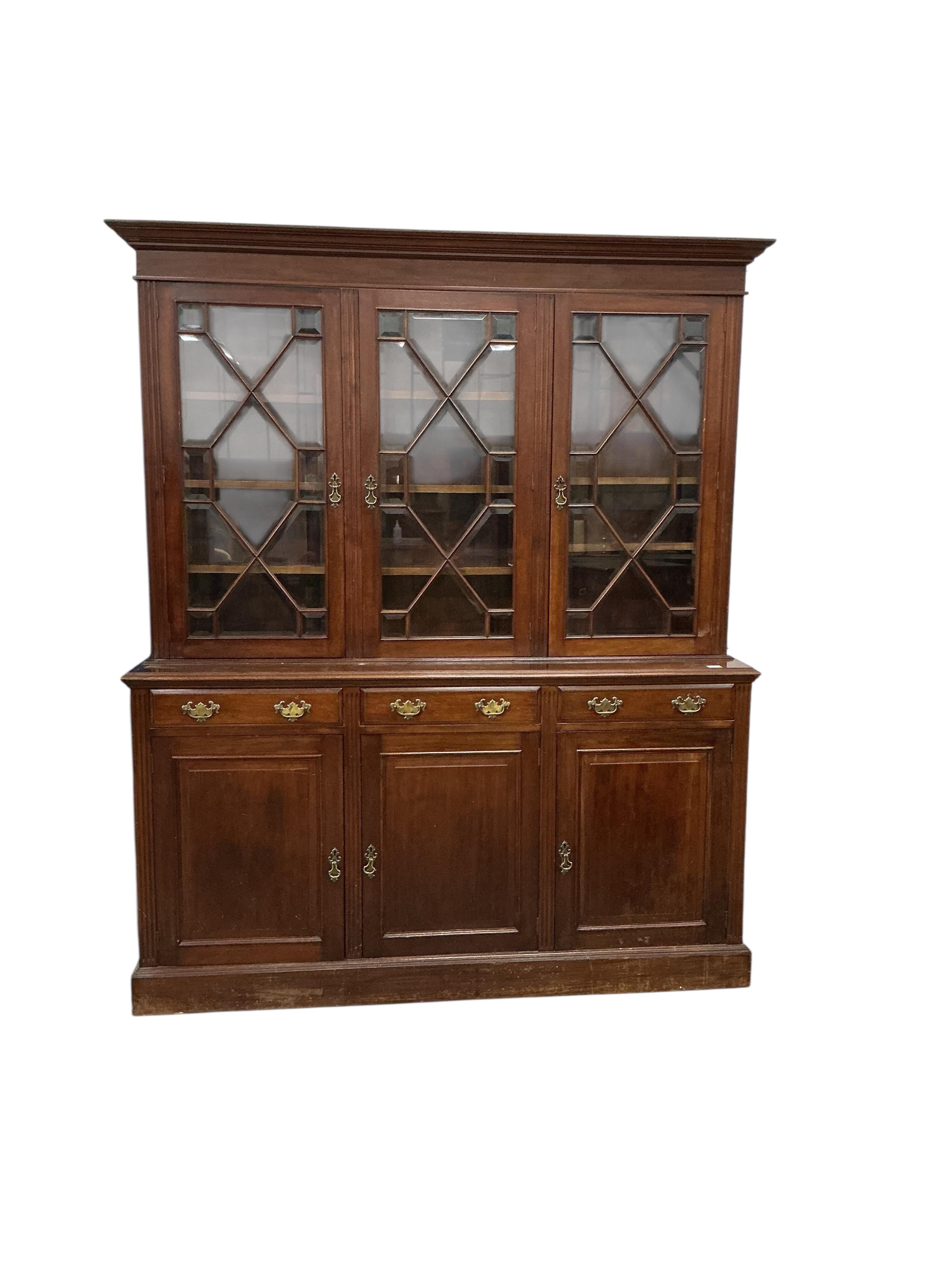 A late Victorian mahogany library bookcase with glazed upper section, width 184cm, depth 46cm, height 222cm